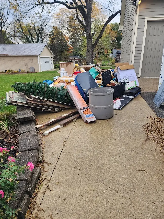 Dumpster being loaded with debris for 12 Yard Dumpster Rental in Lopatcong